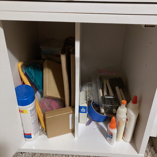 Cabinet with random craft supplies.