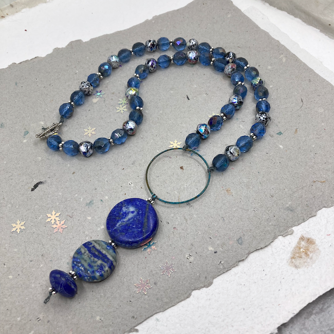 Necklace with various blue beads. 