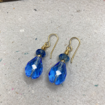 Earrings with blue beads and gold findings.