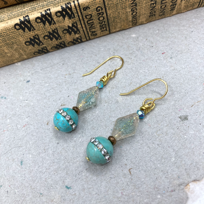 Earrings with rhinestone and turquoise, glass, and crystal beads. 